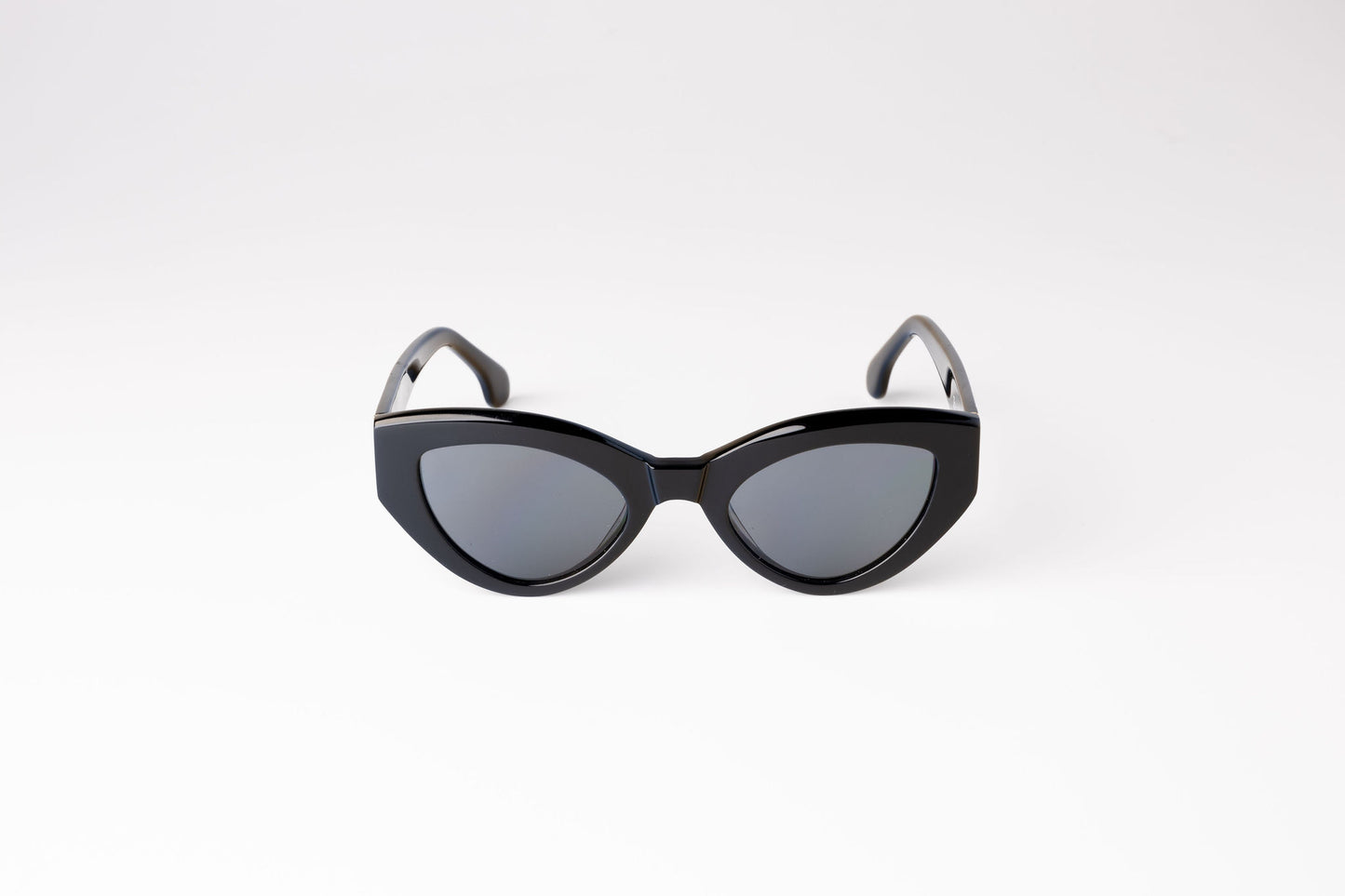 front view of black biodegradable sustainable cateye sunglasses with dark grey lens