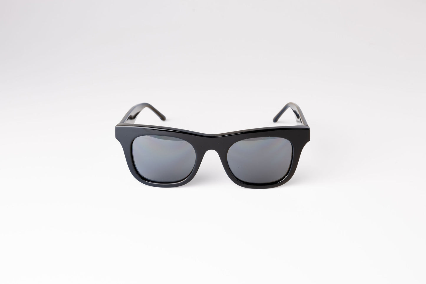 Front view of black Ike Charcoal classic biodegradable and sustainable sunglasses with dark grey lens
