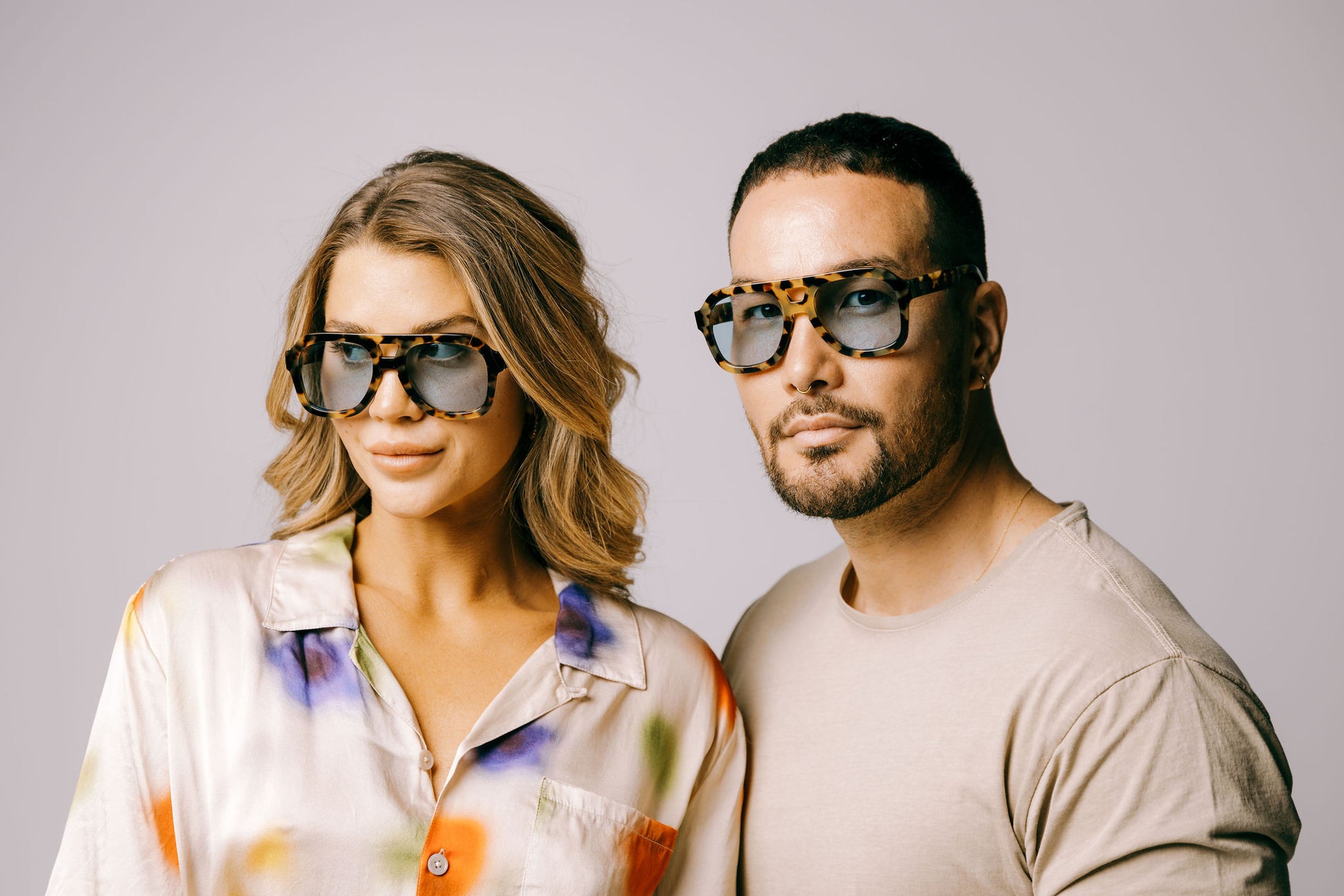 Woman and man wear dark tortoiseshell aviator biodegradable and sustainable malone brulee blue sunglasses with blue lens