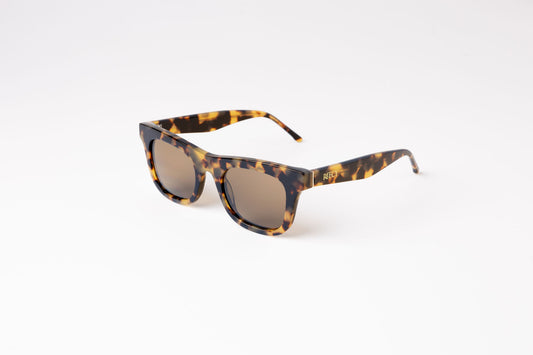 angle view of brown tortoiseshell biodegradable and sustainable sunglasses with tan lens