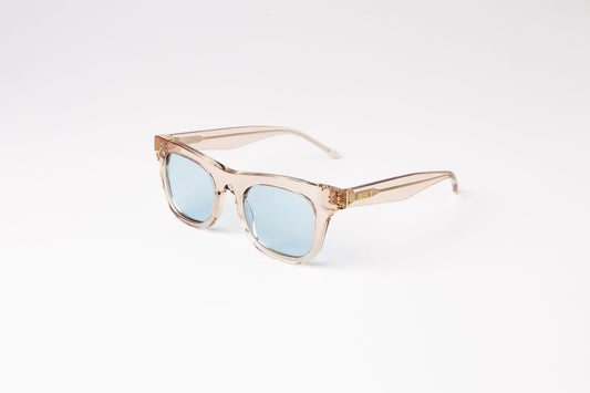 angle view of peach clear biodegradable and sustainable ike oat clue sunglasses with blue lens