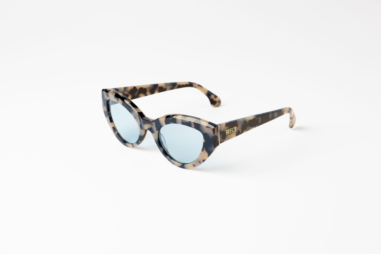 Angle view of light tortoiseshell cateye sustainable and biodegradable Cleo Quinoa Blue sunglasses with light blue lens